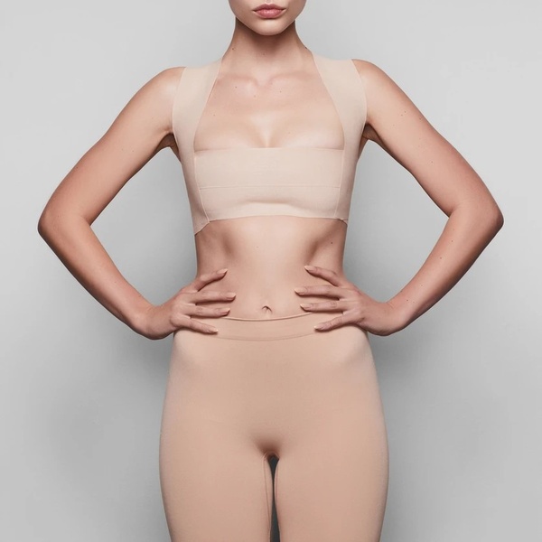 A clean, studio-lit hero shot highlighting the silhouette and fit of the body tape on a neutral background.